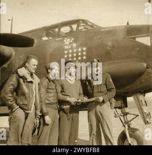 UNITED STATES ARMY AIR FORCES (USAAF) IN BRITAIN, 1942-1945 - A bomber crew of the 301st Bomb Group, 12th Air Force plan a mission over Tunisia in front of their A-20 Havoc, 22 December 1942.Passed as censored 22 Dec 1942. Printed caption on reverse: 'Off To Attack An Enemy Target In Tunisia. Associated Press Photo Shows:- Left to right, Sergt. Benny B. Cunningham, from Plantersville, Miss., Sergt. Earl W. Thompson, from Canaan, N.H.; Major Charles C. Kegelman, from El Reno, Oklahoma, and Lieut. Randall M. Dorton Jnr., of Long Beach, California, plan the attack on their target in Tunisia. Majo Stock Photo