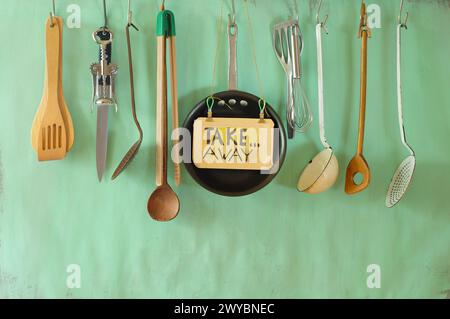 various professional kitchen utensils and take away sign, delivery service offer,food and drink, gastronomy business concept, free copy space Stock Photo