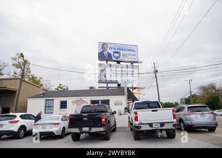 Hamburger King in Montgomery, AL, with its parking lot full, sits beneath billboards, highlighting community events and services on November 22, 2023. Stock Photo