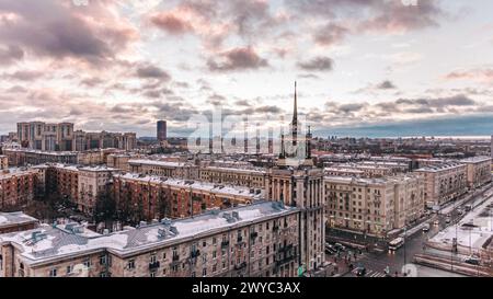 The warm hues of dusk settle over a snow-dusted cityscape St. Petersburg, with historic architecture standing prominently against a dramatic sky. Moskovsky Prospekt in St. Petersburg. Stock Photo