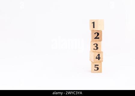 Wooden blocks with number one, two, three, four and five isolated on white background. Ranking or position concept. Stock Photo