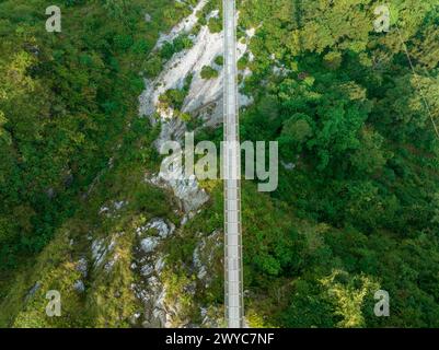 Aerial view of a Tibetan suspended bridge in Nepal is a primitive type of bridge. Wild nature Stock Photo