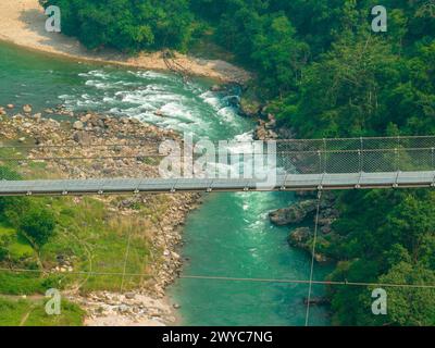 Aerial view of a Tibetan suspended bridge in Nepal is a primitive type of bridge. Wild nature Stock Photo
