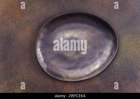 Empty black irregular plate on concrete background. Top view, with copy space Stock Photo