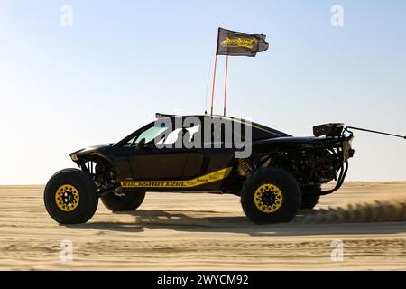 Off road buggy car in the sand dunes of the Qatari desert. Stock Photo