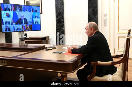 Moscow, Russia. 05 April, 2024. Russian President Vladimir Putin looks at documents as he chairs a video conference meeting with the permanent members of the Security Council from the Kremlin, April 5, 2024 in Moscow, Russia. Credit: Mikhail Metzel/Kremlin Pool/Alamy Live News Stock Photo