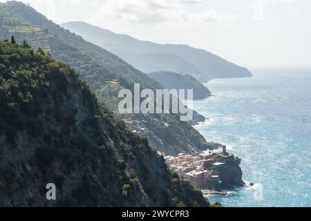 panoramic view to one of Cinque Terre towns Vernazza and mountainous coastline seen from a hiking trail from Monterosso al Mare Stock Photo