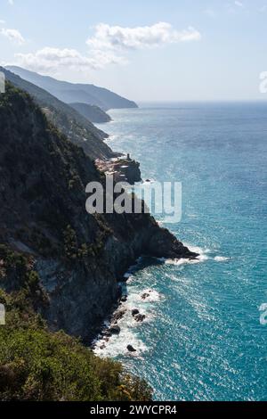 view to one of Cinque Terre towns Vernazza and mountainous coastline seen from a hike from Monterosso al Mare Stock Photo