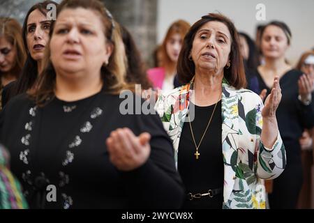 Mosul, Iraq. 05th Apr, 2024. Iraqi Christians worshippers attend the mass at the 80-year-old Chaldean Catholic Church of Um al-Mauna, 'Our Lady of Perpetual Help', in Mosul. With joyful cheers and ululations, Iraqi Christians celebrated the church's restoration with a canonization and dedication ceremony on April 5, years after ISIS turned it into a religious police office and car bomb center. (Photo by Ismael Adnan/SOPA Images/Sipa USA) Credit: Sipa USA/Alamy Live News Stock Photo