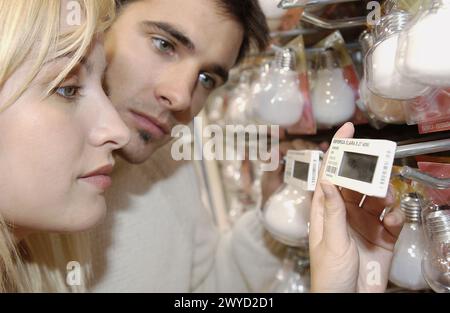 Couple looking at electronic price displays at Eroski shopping center. These displays are updated by remote control. Urbil. Usurbil. Guipuzcoa. Basque Country. Spain. Stock Photo