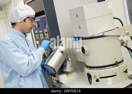 Pouring liquid nitrogen to improve the vacuum in the chamber to deposit thin films Vacuum Coating Systems Cleanroom Microelectronics and Microsystems Unit CEIT Center of Studies and Technical Research University of Navarra, Donostia, Gipuzkoa, Basque Country, Spain. Stock Photo