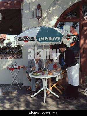 Couple having lunch at outdoor cafe Stock Photo