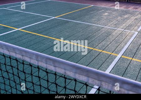 Elevated Platform Tennis, Paddle Ball courts with yellow pickelball lines and net.  Floor surface is green with white and yellow Stock Photo