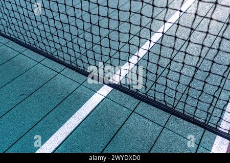 Elevated Platform Tennis, Paddle Ball courts with yellow pickelball lines and net.  Floor surface is green with white and yellow Stock Photo