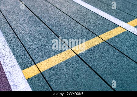 Elevated Platform Tennis, Paddle Ball courts with yellow pickelball lines.  Floor surface is green with white and yellow Stock Photo