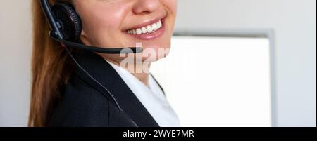 Close up smile of female call center agent. Customer service online agent. Helpline service. Stock Photo