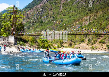 Punakha, Bhutan - Mar 22,2024 Tourists ride on the rafting facility, providing an interesting experience for travel enthusiasts Stock Photo