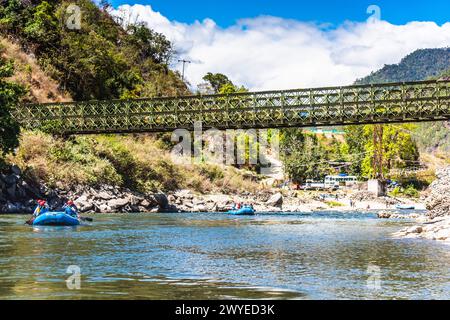 Punakha, Bhutan - Mar 22,2024 Tourists ride on the rafting facility, providing an interesting experience for travel enthusiasts Stock Photo