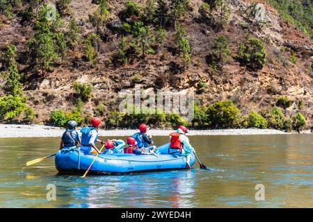 Punakha, Bhutan - Mar 22,2024 Tourists ride on the rafting facility, providing an interesting experience for travel enthusiasts Stock Photo