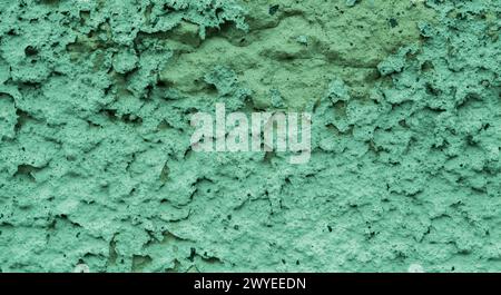 Old peeling paint on the wall..Green abstract background..Beautiful green textured stucco on the wall..Background from green stucco. Stock Photo