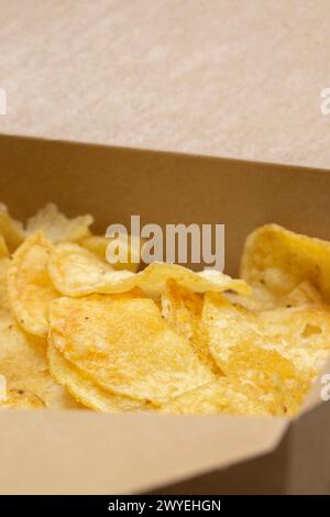 Crisps potato chips, salt and vinegar flavour, in a card carton box. Environmentally friendly biodegradable food packaging. Stock Photo