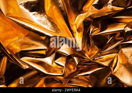 crumpled gold metallic reflector background texture Stock Photo