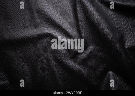Vegan faux Snakeskin leather texture. minimalist and elegant textile. simple dark black backdrop Stock Photo