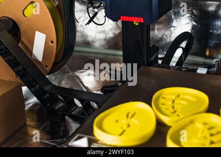 3d printer with some objects on the tray printed with pla filament Stock Photo