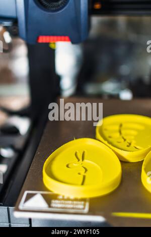 3d printer with some objects on the tray printed with pla filament Stock Photo