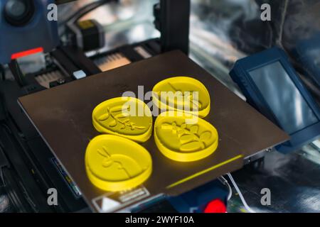 3d printer with some objects on the tray printed with pla filament Stock Photo