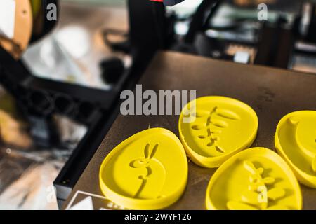 3d printer with some objects on the tray printed with pla filament Stock Photo