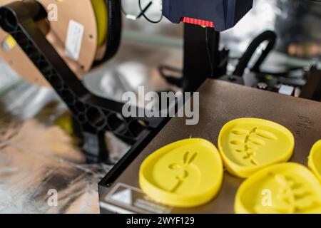3d printer with some objects on the tray printed with pla filament Stock Photo