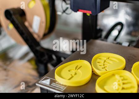 3d printer with some objects on the tray printed with pla filament Stock Photo
