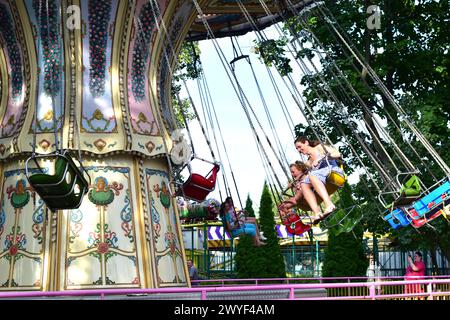 People Ride A Carousel In A City Park. Stock Photo