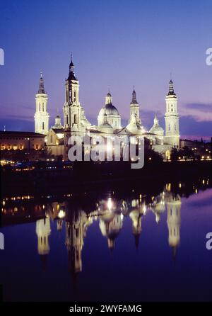Basilica of Nuestra Señora del Pilar and its reflection on river Ebro, night view. Zaragoza, Spain. Stock Photo