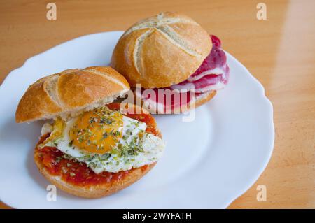 Spanish tapas: fried egg with tomato sauce and Iberian loin. Spain. Stock Photo