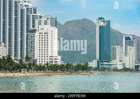 View of central beach of Nha Trang, Vietnam. Beautiful sand tropical beach in coastal city. Scenic coastline. Cityscape Nha Trang is a popular tourist Stock Photo