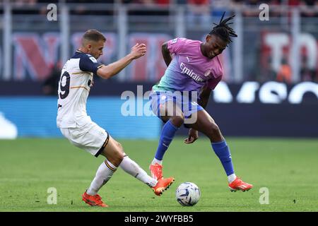 Milano, Italy. 06th Apr, 2024. Alexis Blin of Us Lecce battle and Rafael Leao of Ac Milan for the ball during the Serie A match beetween Ac Milan and Us Lecce at Stadio Giuseppe Meazza on April 6, 2024 in Milan, Italy . Credit: Marco Canoniero/Alamy Live News Stock Photo