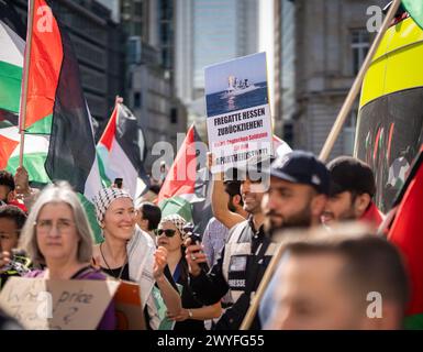 06 April 2024, Hesse, Frankfurt/Main: Demonstrators kneel down in ...