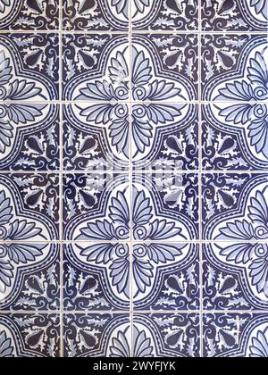 A pattern made of traditional blue floral Spanish tiles on a wall Stock Photo