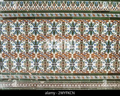 A pattern made of traditional colorful floral Spanish tiles on a marble wall, background texture for text, graphic resource, Cadiz, Andalusia, Spain Stock Photo