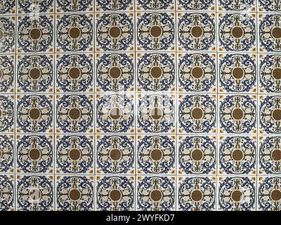 A pattern made of traditional colorful floral Spanish tiles on a marble wall, background texture for text, graphic resource, Cadiz, Andalusia, Spain Stock Photo