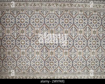 A pattern made of traditional colorful floral Spanish tiles on a marble wall, background texture for text, graphic resource, Cadiz, Andalusia, Spain Stock Photo