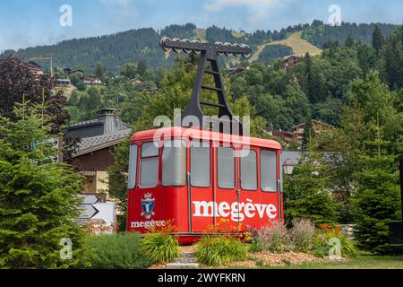 An old red cabin of the Rochebrune cable car on display on a public garden of the popular alpine ski resort in summer, Megeve, Haute Savoie, France Stock Photo