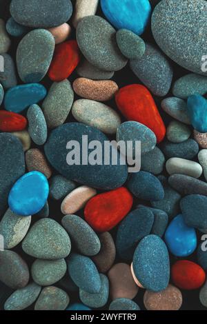 Black, red and turquoise pebbles, stone background. Abstract nature background of pebbles. Stock Photo