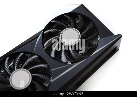 A black and white video card on a white background. Fans and the graphics card case. Computer accessories. Stock Photo