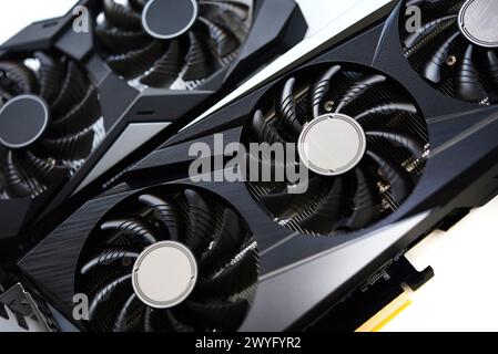 A black and white video card on a white background. Fans and the graphics card case. Computer accessories. Stock Photo