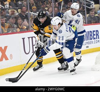 Pittsburgh, United States. 06th Apr, 2024. Pittsburgh Penguins defenseman Ryan Shea (5) and Tampa Bay Lightning center Michael Eyssimont (23) races to the pick during the first period at PPG Paints Arena in Pittsburgh on Thursday, April 6, 2024. Photo by Archie Carpenter/UPI. Credit: UPI/Alamy Live News Stock Photo
