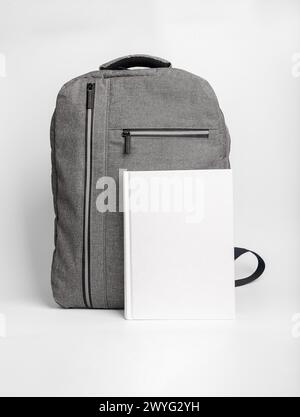 Book cover mockup, textbook mock up at school bag, backpack. Stock Photo