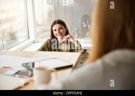Confident women designers discussing new ideas of creating fashion collection Stock Photo
